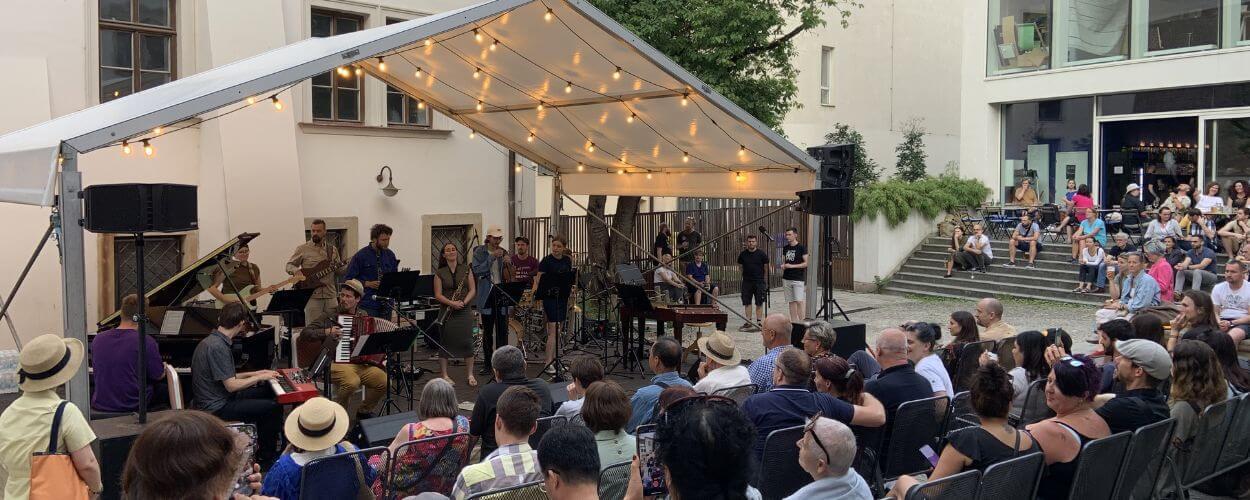 Mladí jazzoví hudebníci hrají na letním open-air festivalu. Pozvánka na akci Jazzové nádvoří v brněnském Divadle Husa na provázku. KULTINO*