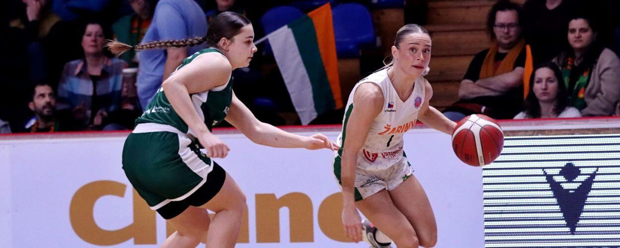 Basketbalistka brněnských Žabin uniká s míčem bránící soupeřce při vyhroceném sportovním souboji pod košem. KULTINO*